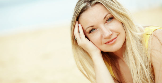 Blonde woman at the beach smiling