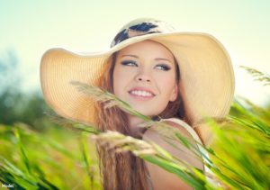 Woman wearing a sun hat in a field