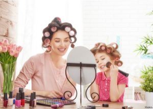 mom and daughter doing their hair together