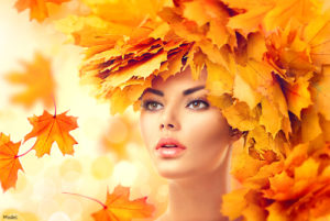 Woman wearing autumn leaves on her head