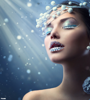 Woman in elaborate blue and white makeup inspired by winter
